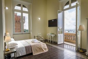 a bedroom with a bed and a balcony with a view at Onlyrooms IV - Sea View & Free Parking in Cagliari