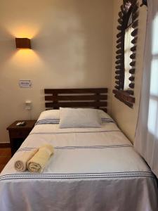a bedroom with a bed with towels on it at Casa Terranova in Puerto Escondido