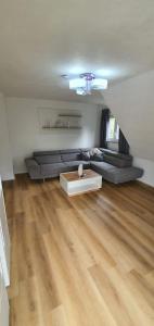 a living room with a couch and a table at Ferienwohnung Maustadt in Memmingen