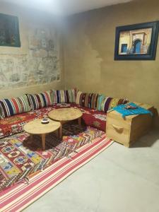 ein Wohnzimmer mit einem Sofa und einem Tisch in der Unterkunft Gîte Mourik in Aghbala