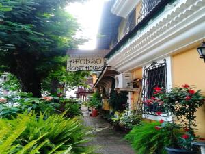 a building with a sign for a guest house at Afonso Guest House - Fontainhas in Panaji +20 photos