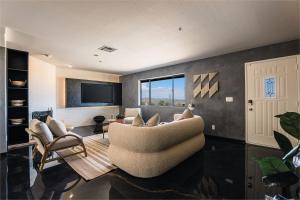 a living room with a couch and chairs and a tv at @ Marbella Lane - Zen-like Ambiance 3BR Home in JT in Joshua Tree