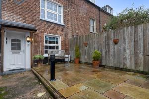 a backyard with a wooden fence and a bench at Dillywicks by Staytor Accommodation in Exeter