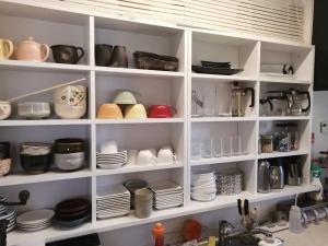 a kitchen shelf with plates and dishes on it at Art Salon Hosokawa - Vacation STAY 13628 in Sapporo