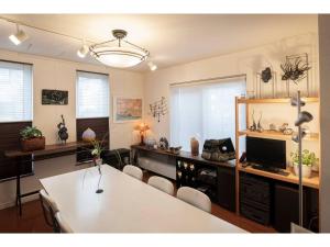 a dining room with a white table and chairs at Art Salon Hosokawa - Vacation STAY 13628 in Sapporo