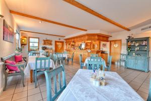 a dining room with tables and blue chairs at Landhotel Jungbrunnen in Bad Brambach