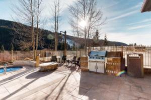 a patio with a stove and a grill with chairs at Red Hawk Lodge 2200 in Dillon