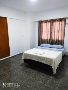 a bedroom with a bed and a dresser at Moderno y amplio apartamento con vista fantástica en pleno centro in Ciudad del Este