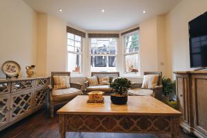 a living room with couches and a coffee table at The Avonmore Olympia in London