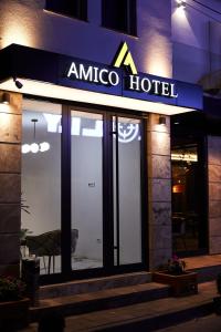 a amico hotel sign on the side of a building at Amico Hotel in Pristina