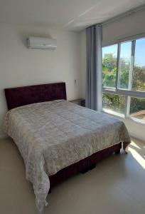 Ένα ή περισσότερα κρεβάτια σε δωμάτιο στο Amplo apto 3 suítes