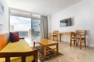 a living room with a couch and a table at Hotel Europalace in Playa del Ingles