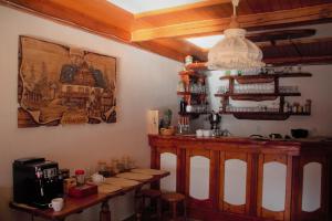 a kitchen with a table and a bar in a room at Pension Luscinia in Harrachov