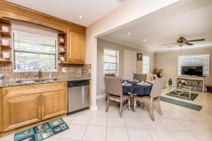 a kitchen with a table and a dining room at OCEAN VACATION BREEZE in Lantana