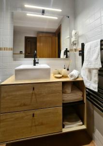 a bathroom with a sink and a mirror at El Rinconcito de la Merced in Toledo +27 photos