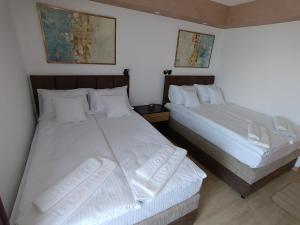 Postel nebo postele na pokoji v ubytování Kumov konak