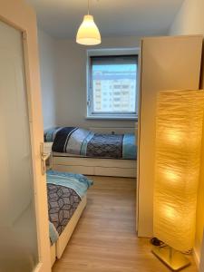 a small room with two beds and a window at Modern Havanna Appartment in Graz