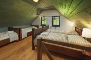 a room with four beds in a attic at Horský dům OLYMPIA in Janske Lazne