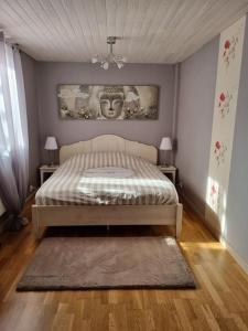 a bedroom with a bed and two tables with lamps at Appartement chaleureux et confortable avec sauna.. in Le Chenit