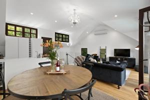 a living room with a table and a couch at Alpine Cottage in Queenstown
