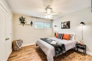 a bedroom with a bed and a ceiling fan at Love for Dallas: Close to Deep Ellum & AAC! in Dallas
