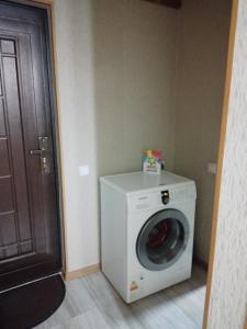 a washer and dryer in a room with a door at Apartment in Tbilisi City