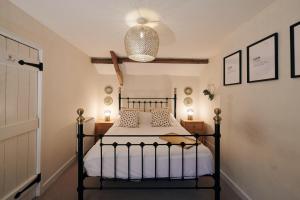 a bedroom with a black bed in a room at Goilan Goch in Llandeilo