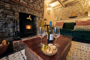 a living room with a table with two wine glasses at Goilan Goch in Llandeilo