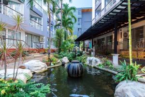 a koi pond in the middle of a building at Hua Hin First-Hin Nam in Hua Hin