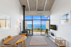 a living room with a view of the ocean at Whitecrest Eco Apartments Great Ocean Road in Apollo Bay