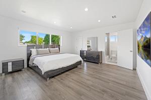 a white bedroom with a bed and a large window at Private Spacious House #BBQ - Hallandale Beach, Florida in Hallandale Beach +21 photos