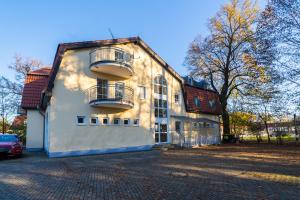 a white building with balconies on the side of it at Fewo Thermal Bad Saarow in Bad Saarow