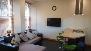 a living room with a couch and a table at Ensuite Rooms in Wick