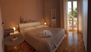 a bedroom with a bed and a table with towels on it at B&B Dei Cardinali in Terni