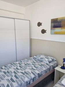 a bedroom with a bed and a painting on the wall at Riverside imbassai bloco B003 in Mata de Sao Joao +12 photos