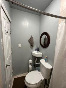 a bathroom with a white toilet and a sink at OQP Vacations Miami in Miami