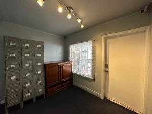 an empty room with lockers and a window and a door at OQP Vacations Miami in Miami