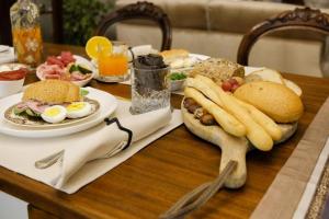 a table with a plate of food with eggs and french fries at B&B Old Town San Marino in San Marino