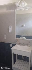 a bathroom with a white sink and a mirror at Chalet de 2 dorm- 1baño - Piscina in Valeria del Mar