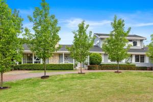 a house with three trees in the front yard at Allambea Mount Eliza in Mount Eliza