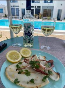 a plate of fish and two glasses of wine at BLU in Puerto del Carmen