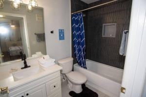 a bathroom with a toilet and a sink and a shower at Cozy Studio Apartment close to Disney in Davenport