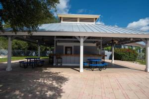 a pavilion with picnic tables and chairs under it at Cozy Studio Apartment close to Disney in Davenport