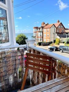 a bench on a balcony with a view of a street at 3 Bedroom Spacious Seaside Apartment with Estuary Views in Southend-on-Sea