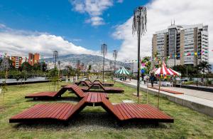 a group of picnic tables in a park at Lovely apartment in the best zone of Medellin in Medellín
