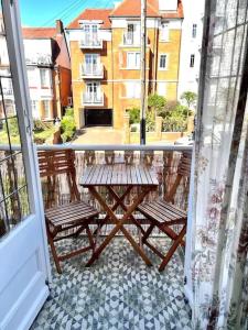 d'un balcon avec deux bancs et une table sur une terrasse. dans l'établissement 3 Bedroom Spacious Seaside Apartment with Estuary Views, à Southend-on-Sea