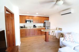 a kitchen with a couch and a table in a room at New One Bedroom Suite West Bay Roatan - Number 6 in West Bay