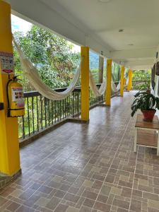 um quarto com um alpendre com redes de descanso na varanda em La Casablanca Tayrona House em Calabazo