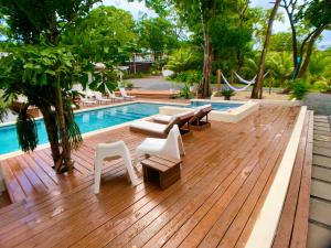 a wooden deck with chairs and a swimming pool at New One Bedroom Suite West Bay Roatan - Number 6 in West Bay