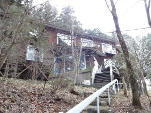 a house on a hill in the woods at Pension Logette Sanbois in Nikko